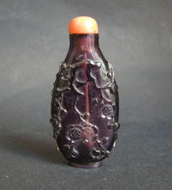 Snuff bottle overlay glass amethyst color sculpted of flowery branches and prunus